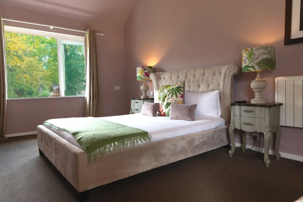 Bedroom with a green throw and garden window at The Old Red Lion