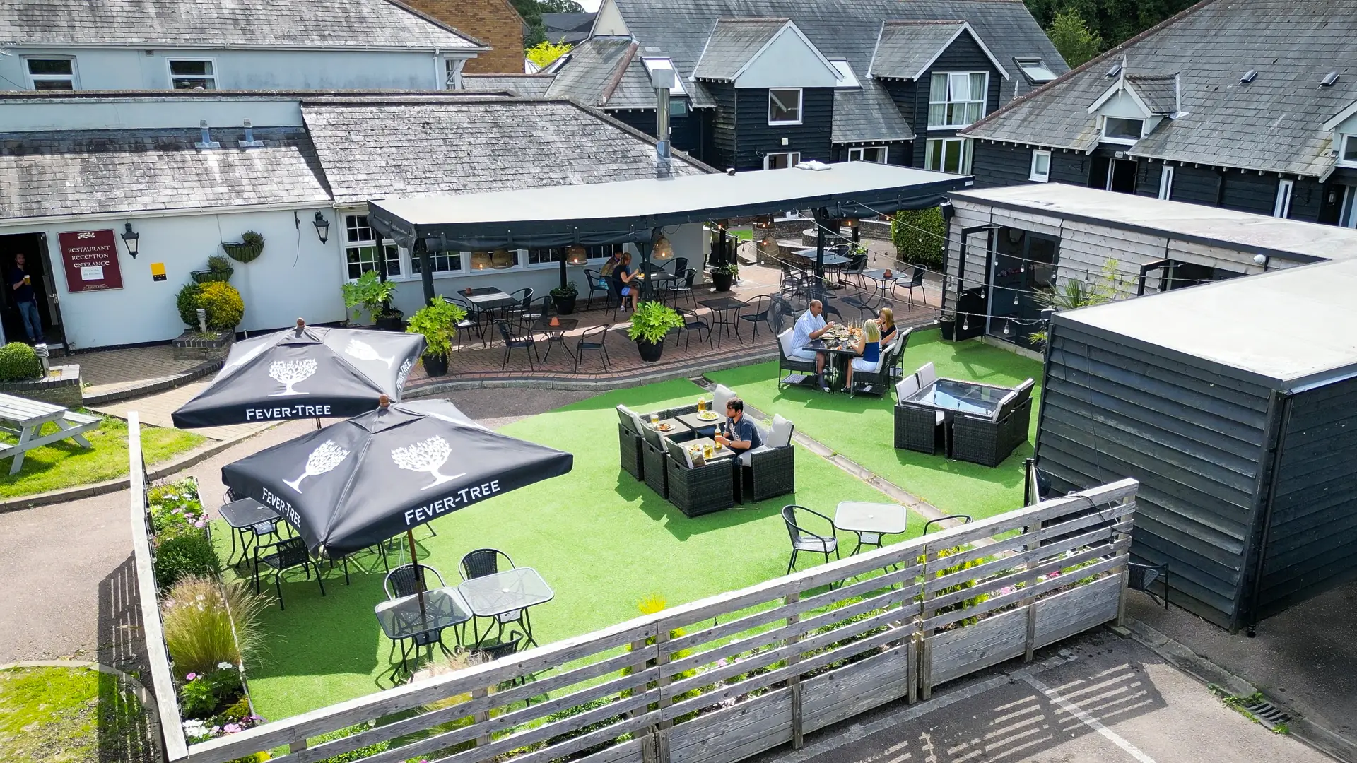 Aerial view of the garden, dining pods and parasols at The Old Red Lion