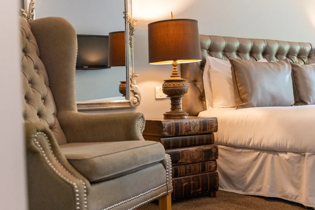 Wingback armchair and bedside lamp in a bedroom at The Old Red Lion