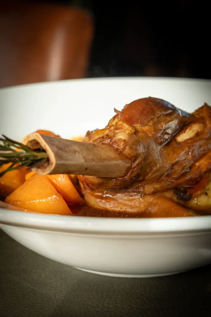 Slow-cooked lamb shank with roasted vegetables