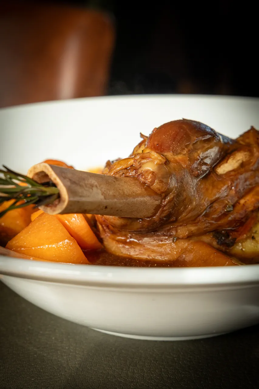 Slow-cooked lamb shank with roasted vegetables