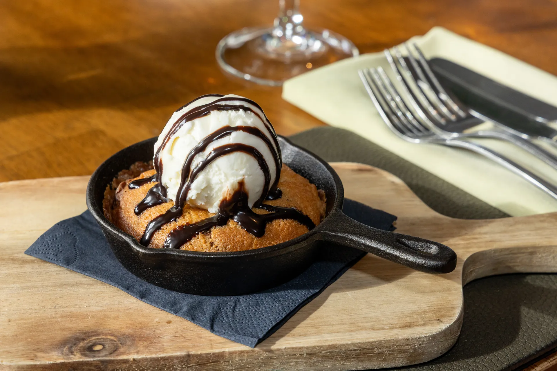 Baked skillet dessert topped with ice cream and chocolate sauce at The Old Red Lion, Horseheath