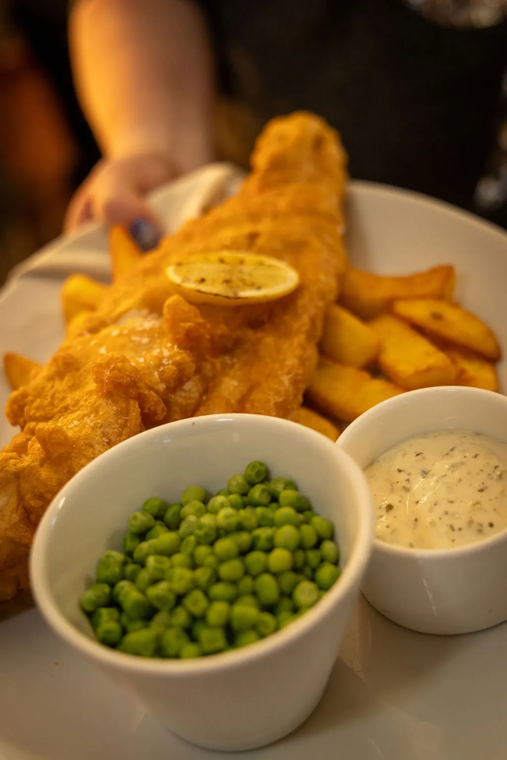 Battered fish and chips with peas and tartare sauce