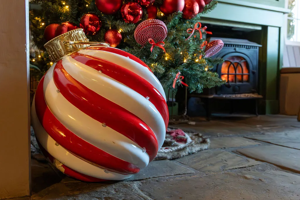 Large red and white striped Christmas baubles at The Old Red Lion, Horseheath