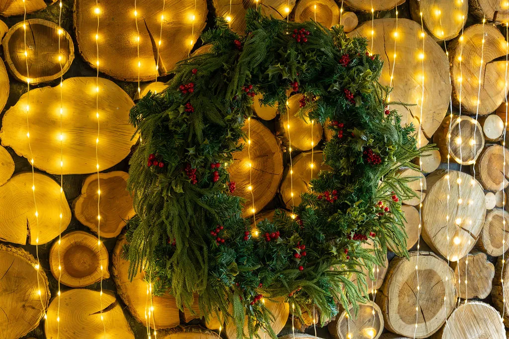 Lit Christmas wreath with gold baubles at The Old Red Lion, Horseheath